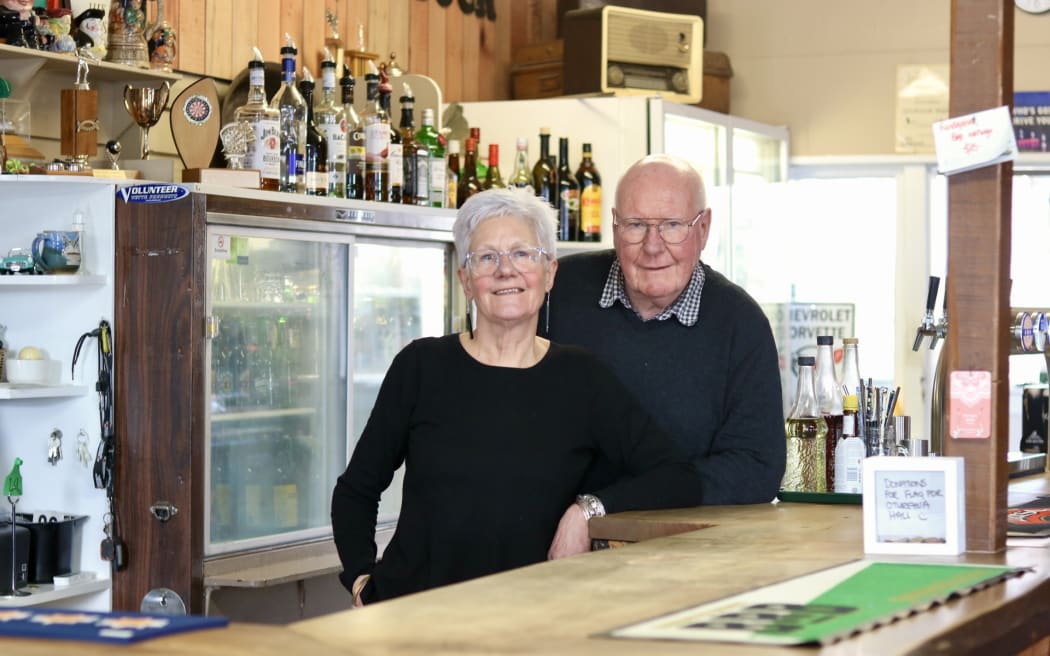 Grahame and Liz Jones in September 2025, in the Oturehua Railway Hotel, which they have run for 17 years and describe as the front room of the community.