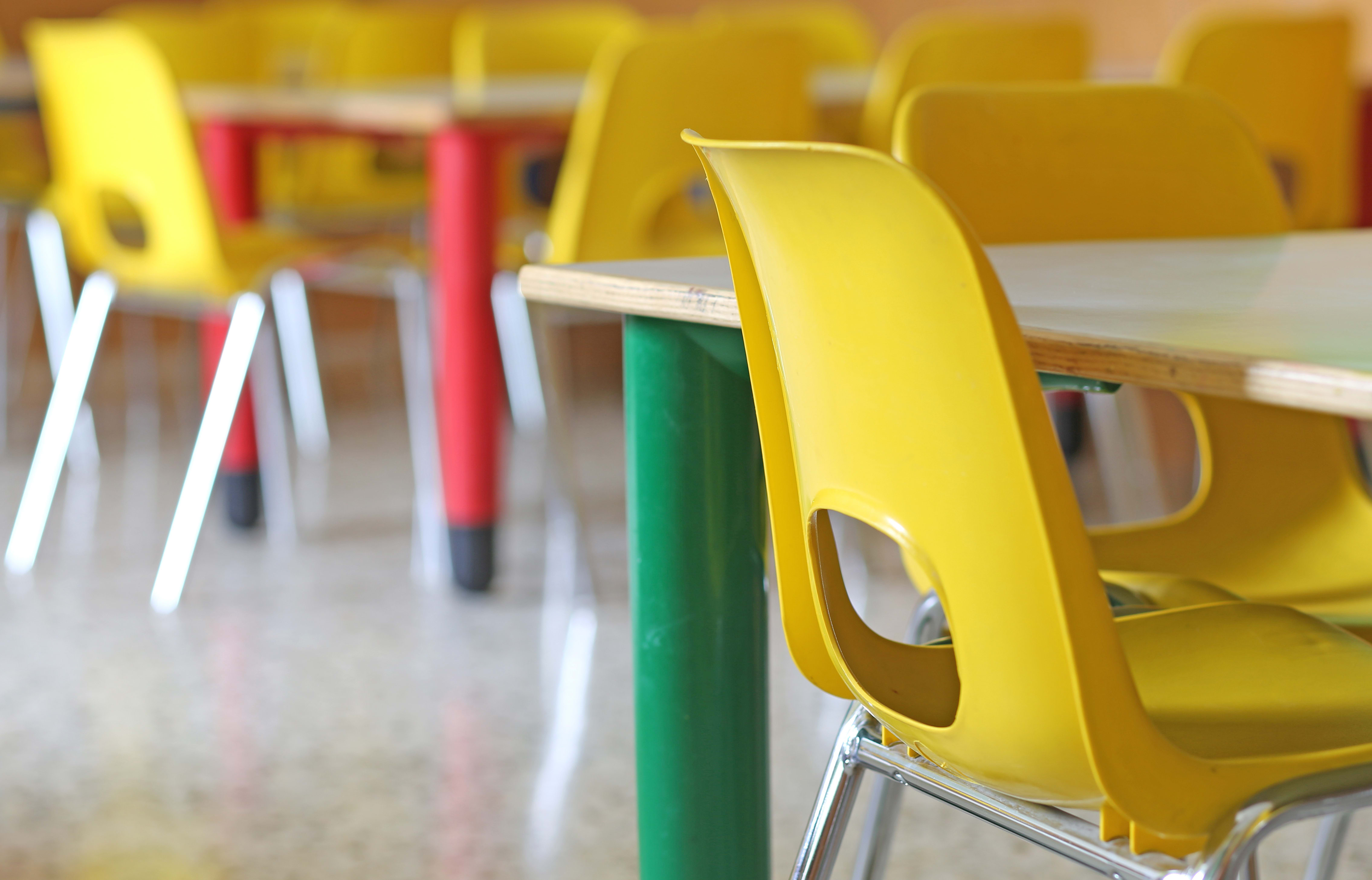 A file photo shows bright yellow chairs in a kindergarten or pre-school.