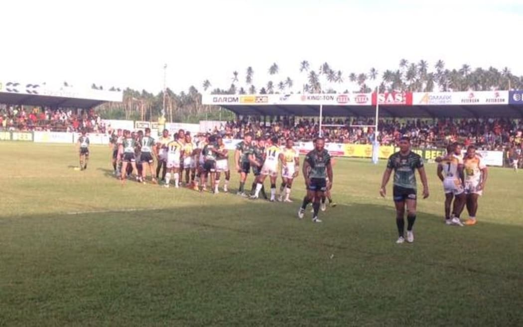 PNG Hunters and Ipswich Jets players shake hands following the home team's victory in Kokopo.