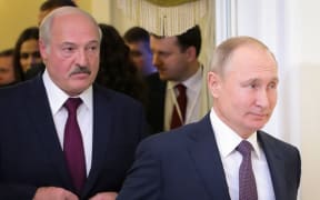 (FILES) This file photo taken on December 20, 2019 shows Russian President Vladimir Putin (R) followed by Belarusian President Alexander Lukashenko (L), entering a meeting hall during the Supreme Eurasian Economic Council, in Saint Petersburg. -