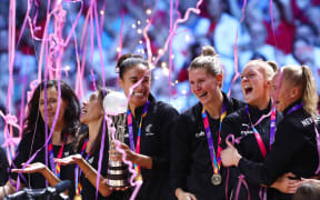 Maria Folau holds the World Championship Trophy as the team celebrate winning the Netball World Cup with a 52-51 victory over Australia in the final.