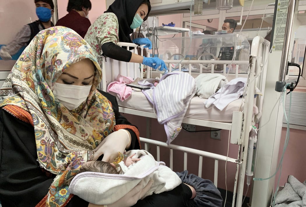 An Afghan mother feeds a newborn baby who survived the attack on MSF hospital, in Kabul.