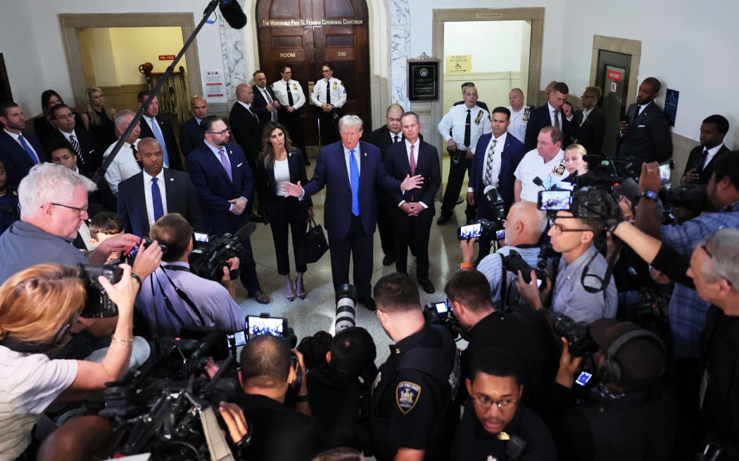 Former US President Donald Trump speaks to the media as he arrives for the start of his civil fraud trial at New York State Supreme Court on October 2, 2023 in New York City.