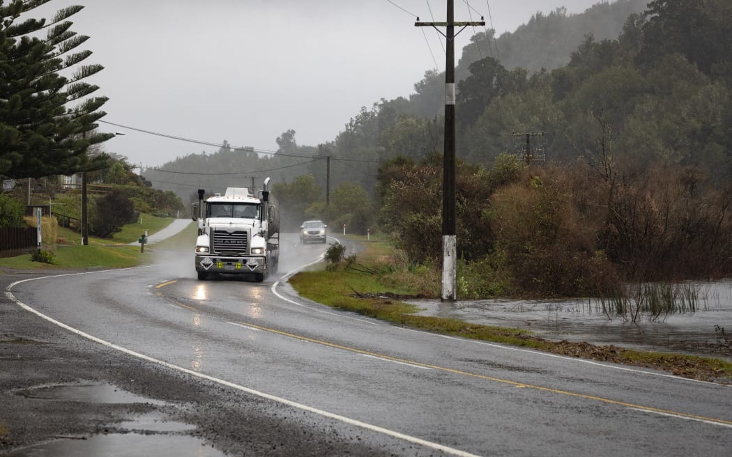 Lake water is nearly at the roadside along State Highway 30.