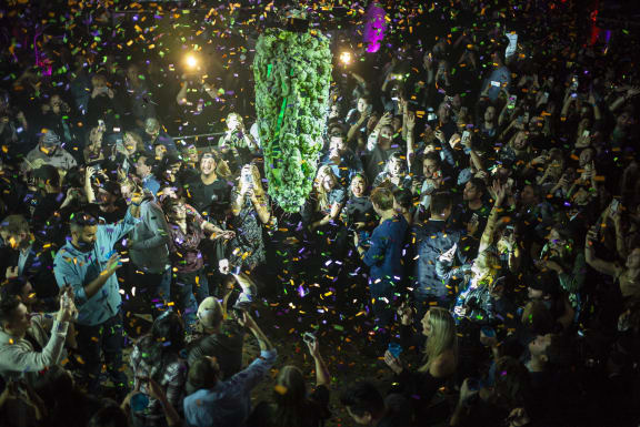 orontonians gather at a local concert venue to watch the "bud drop" at the stroke of midnight, in celebration of the legalization of recreational cannabis.