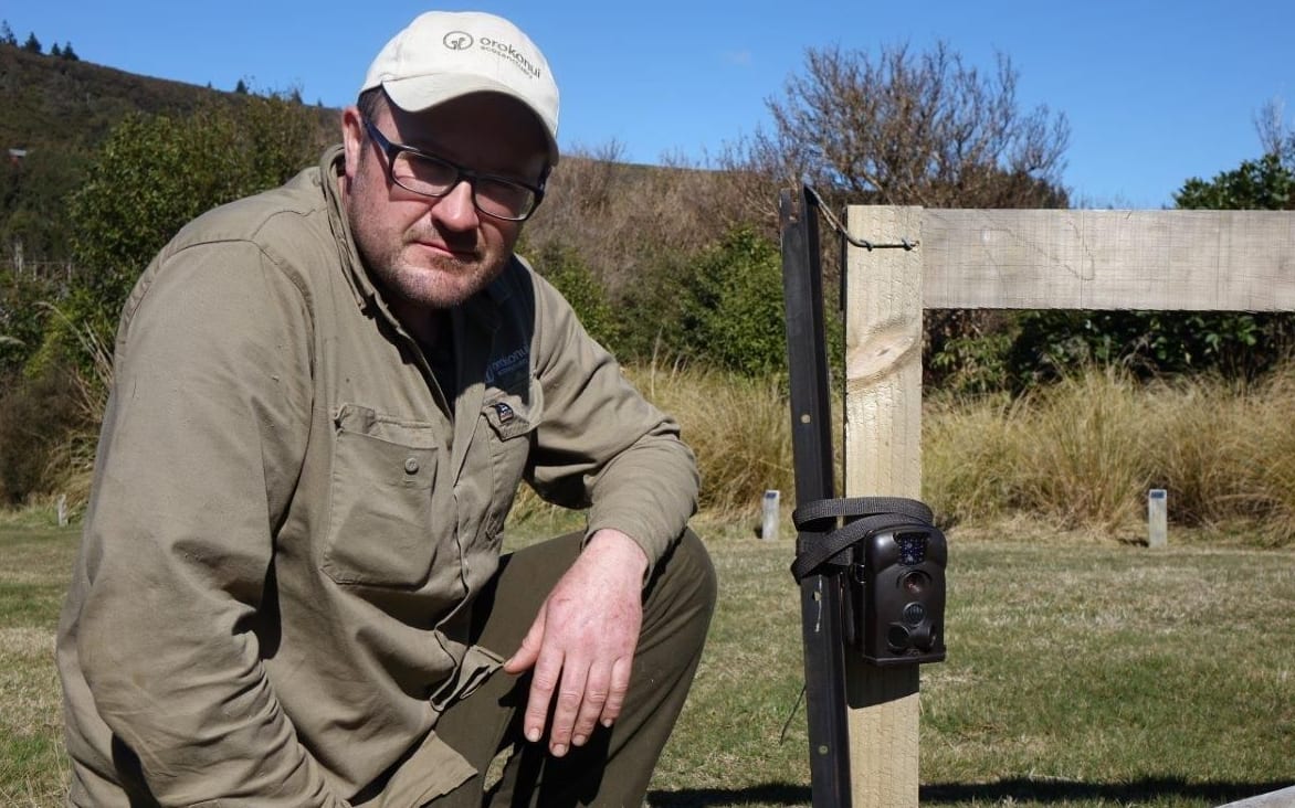 Orokonui's conservation manager, Elton Smith, with one of the motion cameras used to spot the stoat.