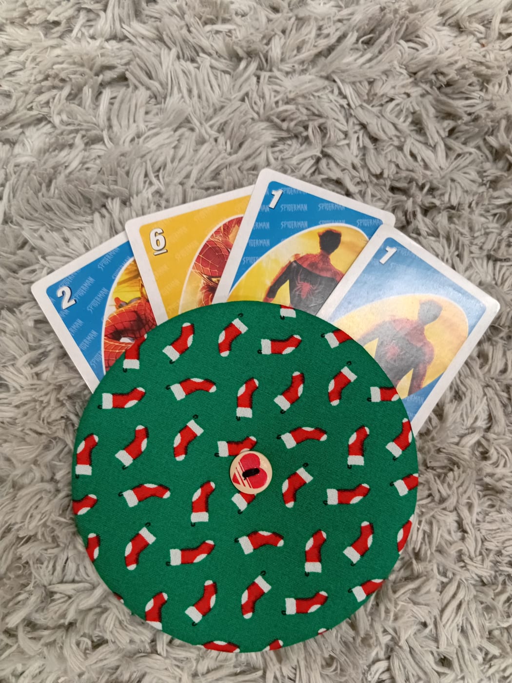 Picture shows a round disc turned into card holder, it's covered with beautiful patterned fabrics.