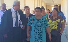 Leutogi Te'o (C) and Luse Tauvale (R) talking to their lawyer after entering guilty pleas