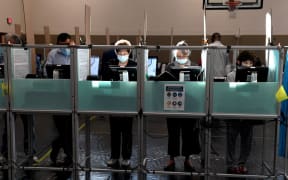 LAS VEGAS, NEVADA - NOVEMBER 03: People including Diane Stein (center L) and Marietta Navarro (center R) vote at Desert Breeze Community Center on November 3, 2020 in Las Vegas, Nevada.