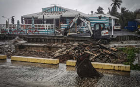 An excavator clearing the debris from the harbour area at Trader Jack’s, one of the most popular spots on Rarotonga. TALAIA MIKA/ 24121737, 24121738, 24121739