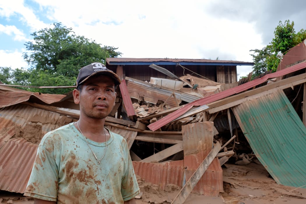 Devestation in Thahin village after the collapse of an under-construction dam in south-east Laos.

Mr. Khambone in front of the remains of his house.