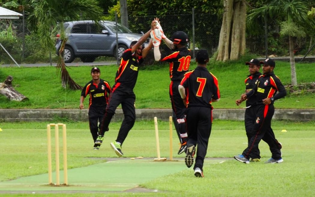 The PNG Garamuts celebrate a wicket.