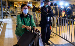 Passengers leave the World Dream cruise ship in Hong Kong on 9 February.