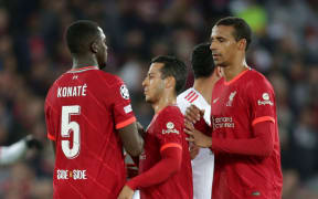 Ibrahima Konate of Liverpool  shakes hands with team mates Thiago Alcantara and Joel Matip