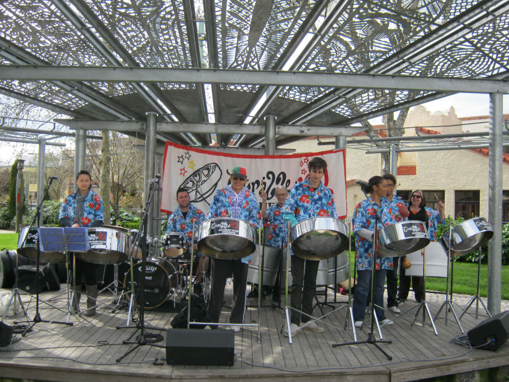 Southern Stars Steel Band. Leader Camille Nakhid is center wearing a cap.