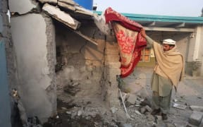 A Pakistani tribesman inspects the site of a drone strike in Mamuzai in the Kurram tribal district.