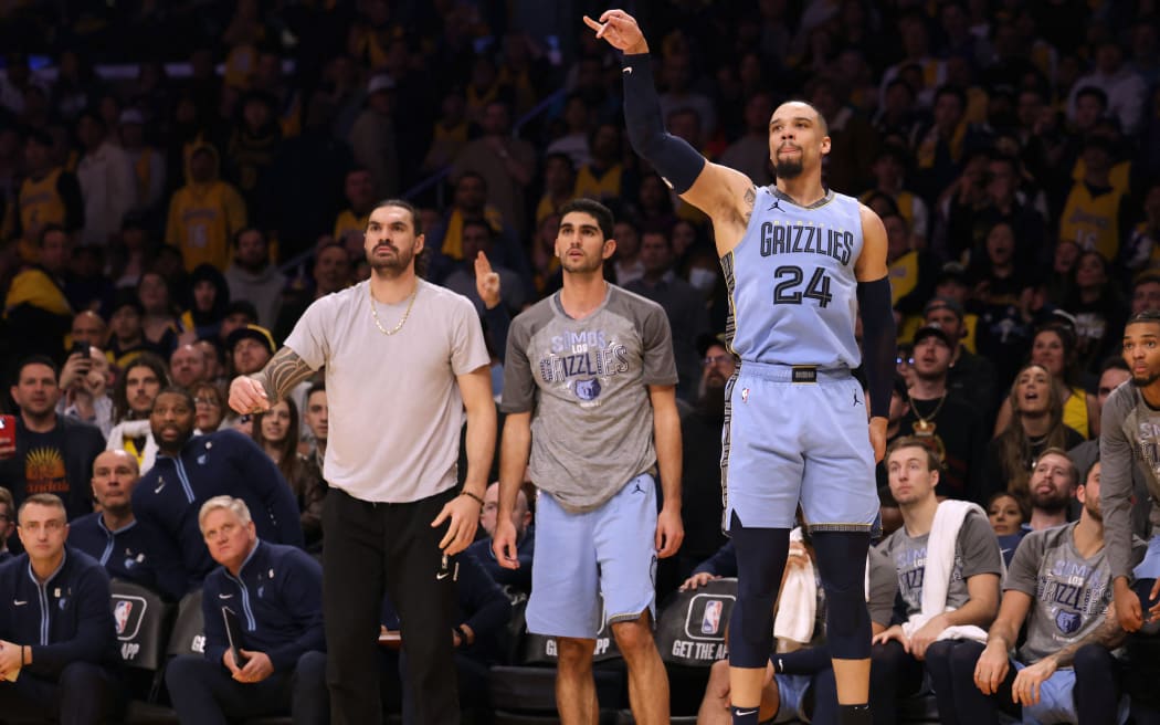 Steven Adams (L) on the sideline at a Memphis Grizzlies NBA game.