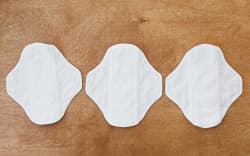Reusable eco natural pads. White feminine washable, healthy and eco friendly pads from cotton and polyester. Stop plastic pollution. Free from perfume and chlorine. Zero waste lifestyle