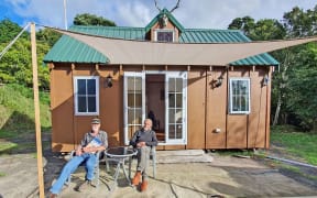 Tiny home owner Pete Montgomery, left, with land owner Ed Reid