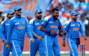 Indian players celebrate a New Zealand wicket at the Champions Trophy match in Dubai.