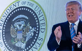 US President Donald Trump arrives to address the Turning Point USAs Teen Student Action Summit 2019 in Washington, DC. Trump stands in front of a presidential seal manipulated to make the eagle resemble Russia's two-headed version.