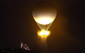 A balloon holds the Olympic cauldron after it was lit during the opening ceremony of the Paris Olympics.