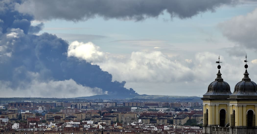 Picture taken from the Almudena cathedral in Madrid shows a huge smoke column caused by a fire in an uncontrolled dump near the town of Sesena,