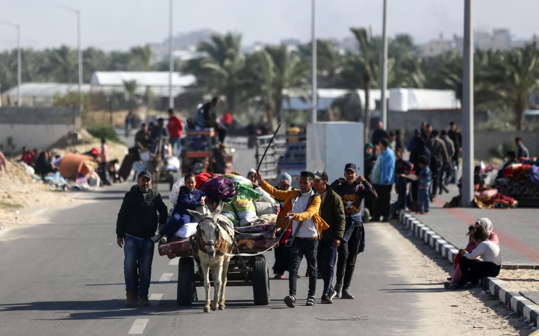 Palestinian families are fleeing the city on the coastal road leading to Rafah from the southern outskirts of Khan Yunis, in the southern Gaza Strip, amid ongoing battles between Israel and the Palestinian militant group Hamas, in Khan Yunis, Gaza Strip, on January 22, 2024. (Photo by Majdi Fathi/NurPhoto) (Photo by MAJDI FATHI / NurPhoto / NurPhoto via AFP)