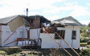 Robyn Hale's home, with her badly damaged bedroom in the foreground, after severe spring storms, in October, 2025.