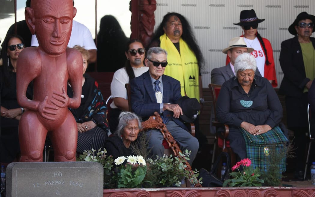 Kīngi Tūheitia (centre) sitting at the mahau, beside Dame Naida Glavish, as a delegation including representatives from Kīngitanga, Rātana, Parihaka and Te Pāti Māori are welcomed on to Te Whare Rūnanga at the Treaty grounds, on 4 February, 2024.