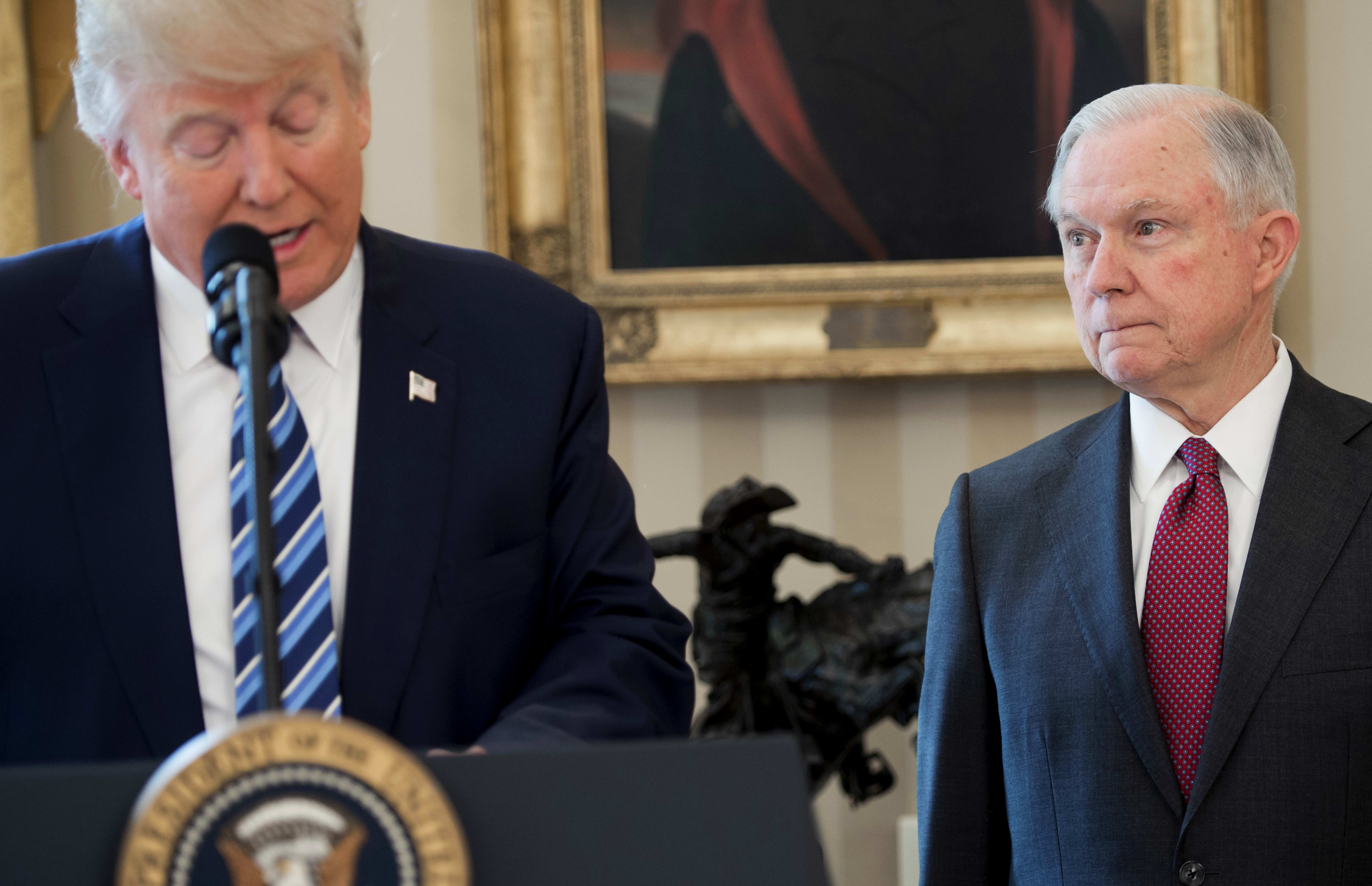 US President Donald Trump alongside US Attorney General Jeff Sessions after Sessions was sworn in as Attorney General in the Oval Office of the White House in Washington, February 9, 2017