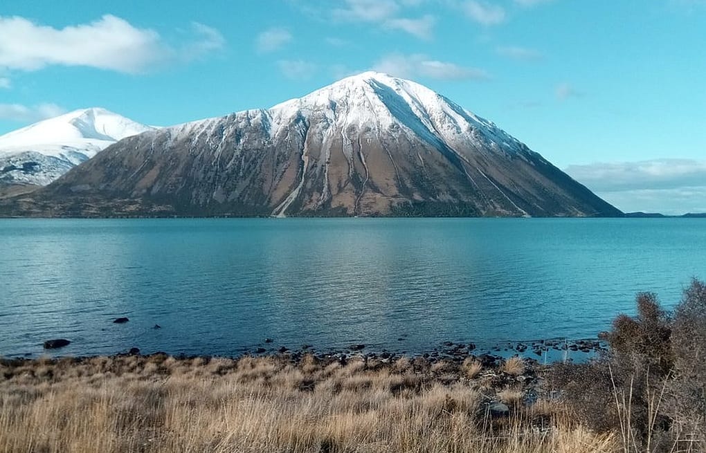 A view across Lake Ohau with a snowy peak in the background.