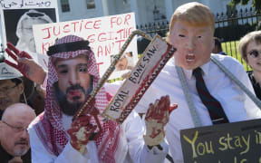 Demonstrators dressed as Saudi Arabian Crown Prince Mohammed bin Salman and US President Donald Trump