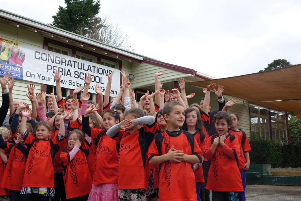 Children at Peria School celebrate the installation of solar panels.