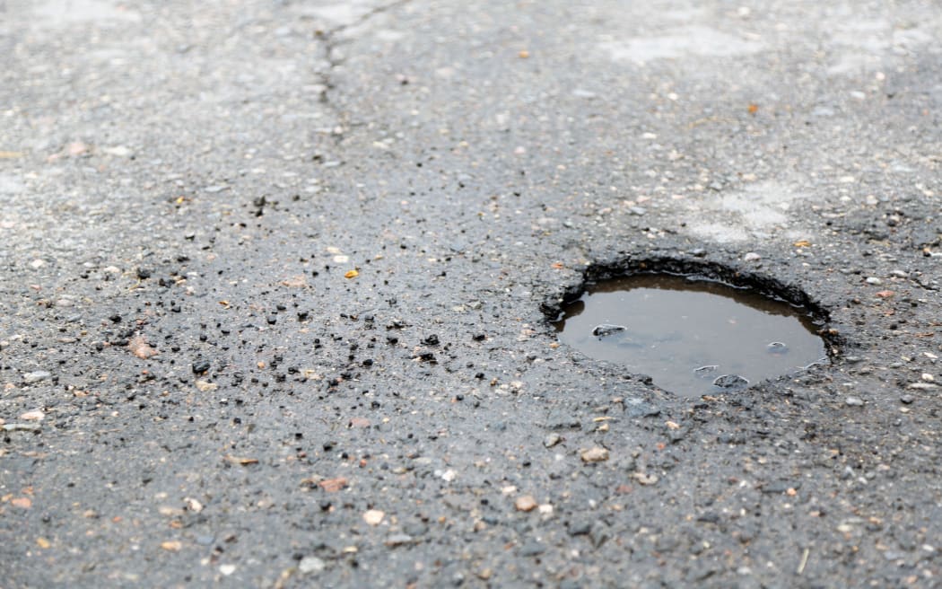 Broken asphalt close up. pothole generic