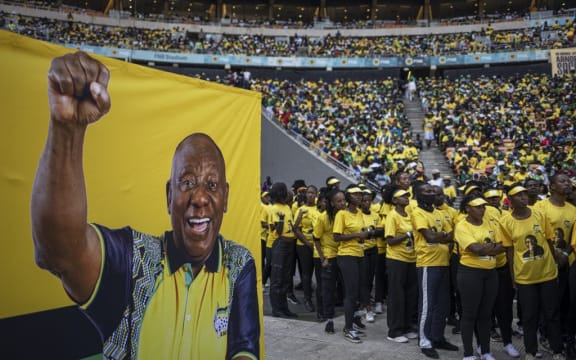 Supporters of the African National Congress (ANC) wear t-shirts with the face of President of the ANC and South African President Cyril Ramaphosa during the ANC's last rally at the FNB Stadium in Johannesburg on May 25, 2024, ahead of the South African elections scheduled for May 29, 2024. (Photo by Michele Spatari / AFP)