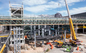 Hydroslides resembling eels being installed at Parakiore Recreation and Sport Centre.