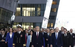 North Atlantic Treaty Organization (NATO) Secretary General Jens Stoltenberg (C) accompanied by the chair of the military committee of NATO Admiral Rob Bauer (front L), and NATO Deputy Secretary General Mircea Geoana (front R) and international foreign ministers attend the alliance's 75th anniversary at NATO Headquarters in Brussels on 4 April, 2024. The NATO military alliance on April 4, 2024, marks the 75th anniversary of the signing of its founding treaty in Washington.