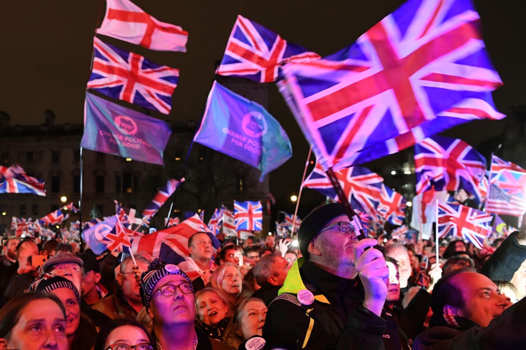 Brexit supporters wave Union flags as they watch the big screen in Parliament Square, venue for the Leave Means Leave Brexit Celebration party in central London.