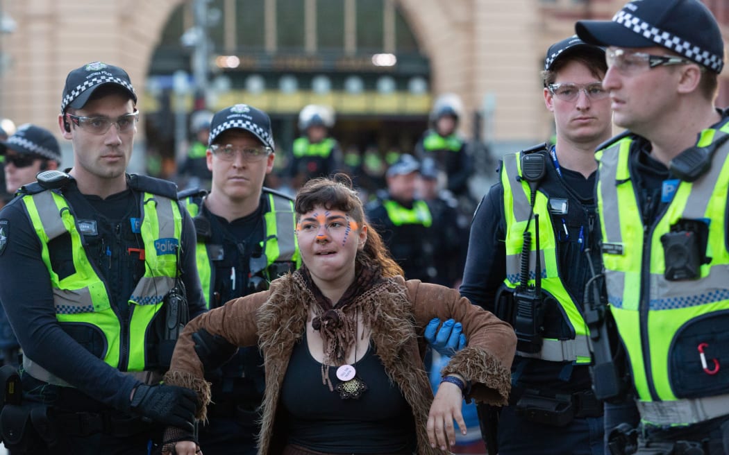 A demonstrator is arrested by police during a Extinction Rebellion protest in Melbourne on October 7, 2019.