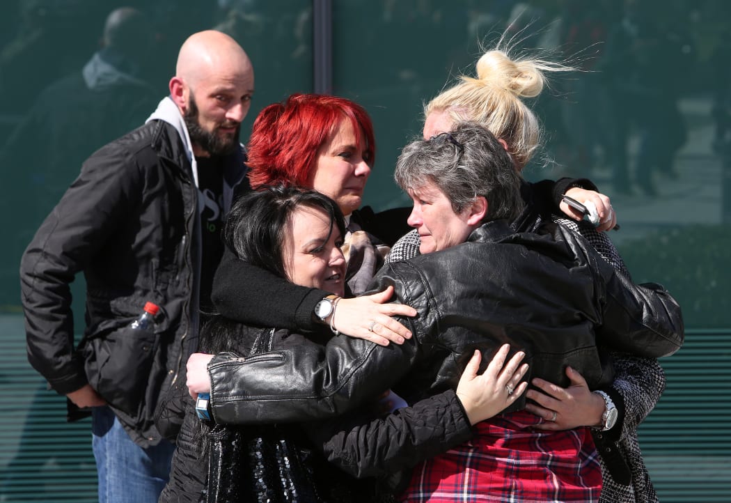 Relatives react the coroner's court in Warrington, north-west England.