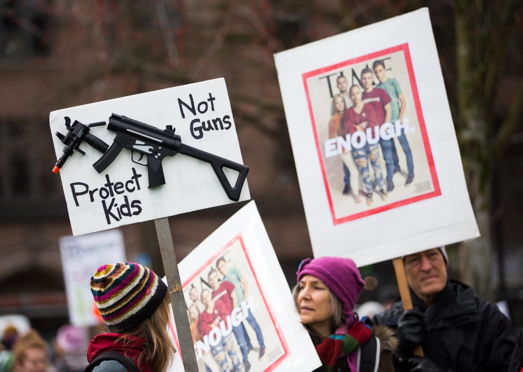 People hold signs during the March for Our Lives rally for Marjory Stoneman Douglas High School students in March 2018 in Seattle, Washington.