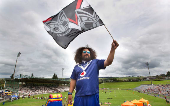 Charlie Raass. NZ Warriors vs Melbourne Storm NRL rugby league trial match at the Rotorua International Stadium.  18 February 2018 Rotorua Daily Post Photograph by Ben Fraser.RGP 23Feb18 - SUPPORTERS: Wayne Temara, Leah Temara, and Dante Temara, 7 are all decked out in their Warriors gear. STAND CHEERS: Thousands of fans take to the stands to cheer on their team. SWISHING: Charlie Raass shows his support with a flag. HUSTLE: Warriors player Lewis Soosemea, right, hustles for the ball.