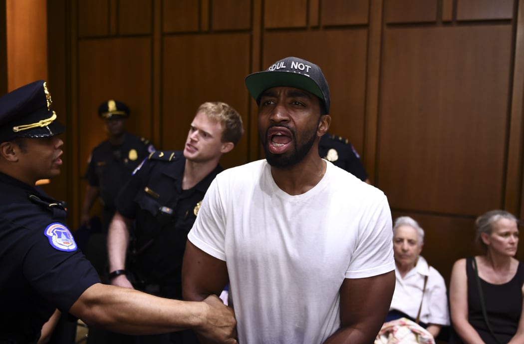A protester is removed during a hearing of the Senate Judiciary Committee on the nomination of Brett Kavanaugh to the US Supreme Court.