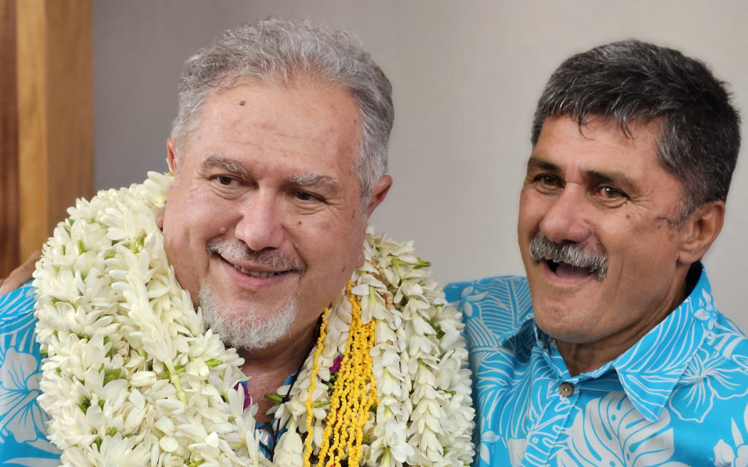 Moetai Brotherson (L) is congratulated by a member of his party after Brotherson was elected president of French Polynesia.