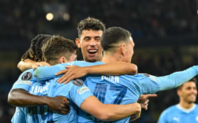 Manchester City players celebrate a goal to Julian Alvarez.