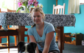 And image of dale Coppin in her house with her dog.