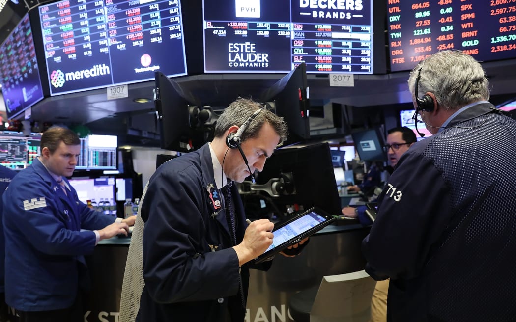 Traders work on the floor of the New York Stock Exchange for Tuesday trading.