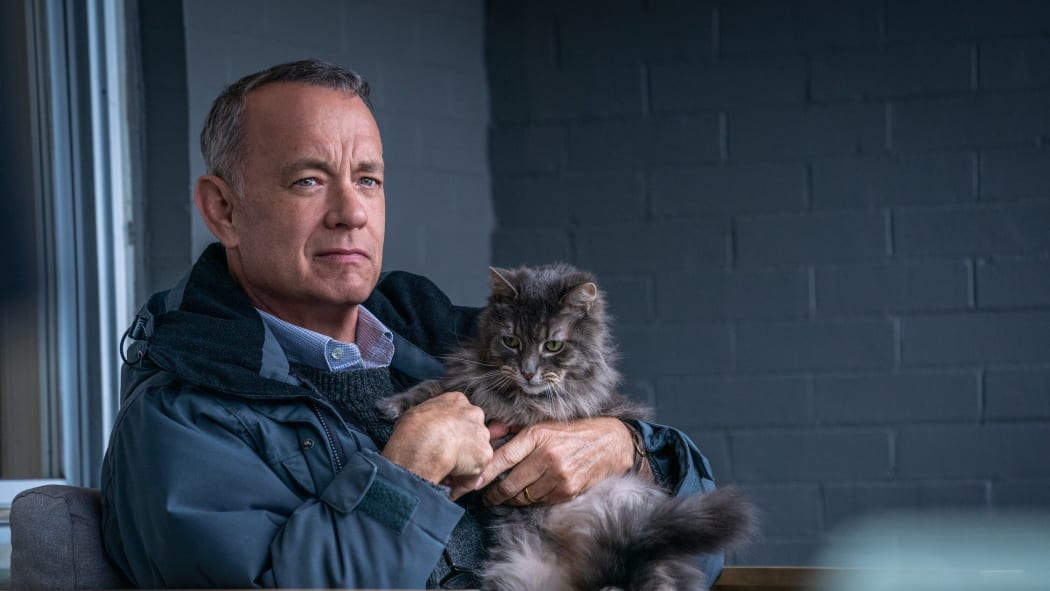 A movie still from the motion picture A Man Called Otto featuring Tom Hanks and a cat.