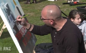 Grieving for his cousin, a man paints as he mourns